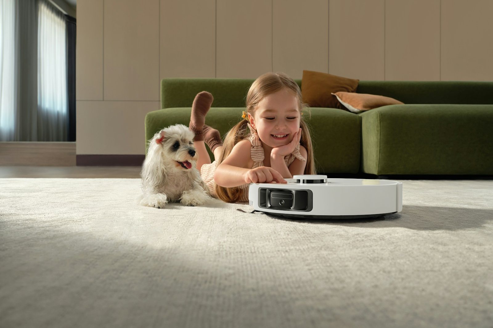 Girl and dog watch robot vacuum cleaner